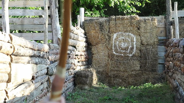 shooting with arrow into haystack target