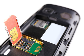 Sim card and smart phone isolated on white