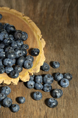Tasty ripe blueberries, on wooden background