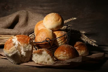 Tuinposter Tasty buns with sesame on wooden background © Africa Studio