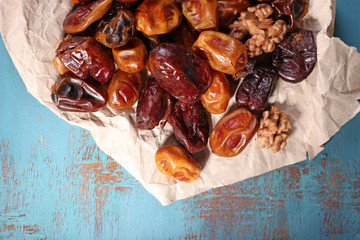 Tasty dates fruits on blue wooden table