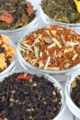 assortment of dry tea in glass bowls