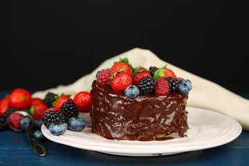Tasty chocolate cake with different berries