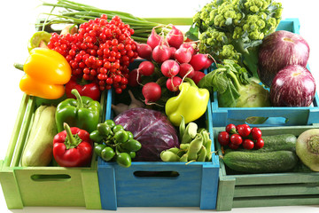 Fresh organic vegetables in wooden boxes, close up