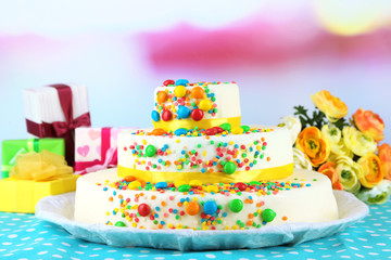 Fototapeta na wymiar Beautiful tasty birthday cake and gifts on light background