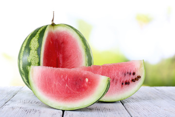 Watermelon on wooden table on natural background