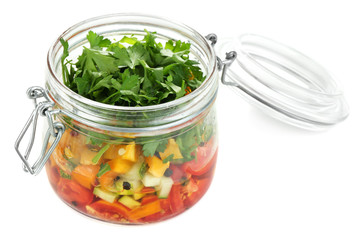 Vegetable salad in glass jar, isolated on white