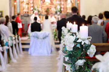 Young couple during the wedding ceremony before the altar in a c