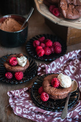 Chocolate cakes with raspberries and whipped cream