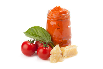 Red pesto in the glass with piece of cheese, cherry tomato and l