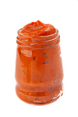Red pesto in the glass isolated on white background.