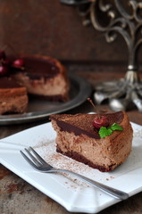 Fototapeta na wymiar Slice of chocolate cheesecake with cherry on top