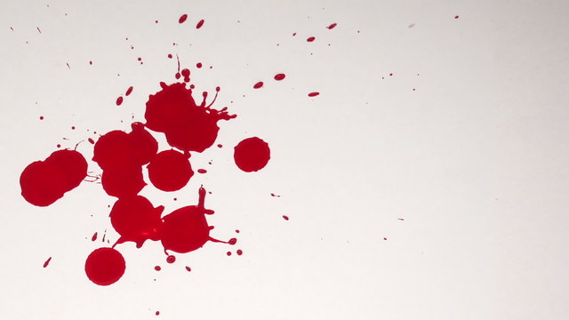 Blood dripping onto a white background.
