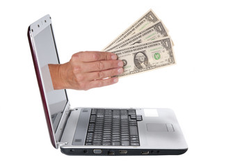 Hand with dollar banknotes comes from the laptop screen