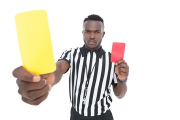 Serious referee showing yellow and red card