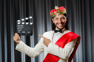 King with movie board in funny concept