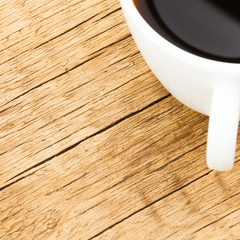 White ceramic coffee cup on old wooden table - 1 to 1 ratio