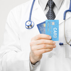 Doctor holding credit cards in his hand - 1 to 1 ratio