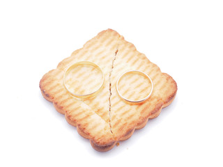 wedding rings and cookies on a white background