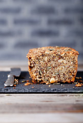 Wholegrain bread with seeds on a stone plate