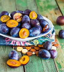 juicy blue plum on a white plate