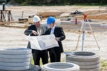 bauleiter besprechen den bauplan auf der baustelle