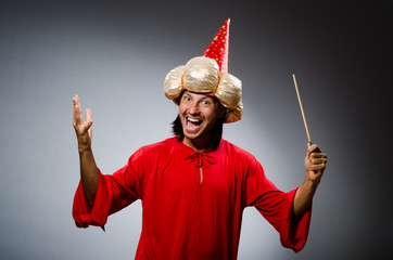 Funny wizard wearing red dress