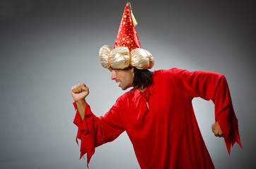 Funny wizard wearing red dress