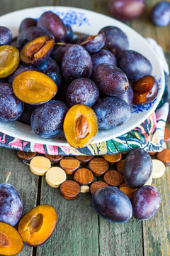 fresh plums on a wooden board, closeup