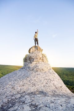Man on top of mountain.