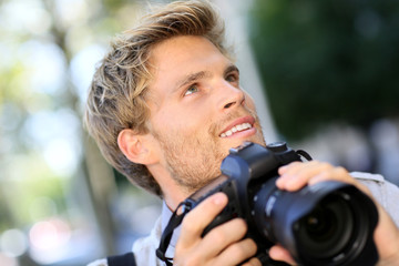 Photographer shooting outside with digital camera