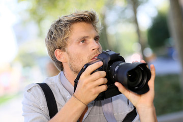 Fototapeta na wymiar Photographer shooting outside with digital camera