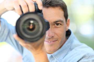 Photographer using reflex camera outside