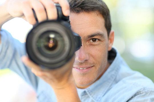 Photographer using reflex camera outside