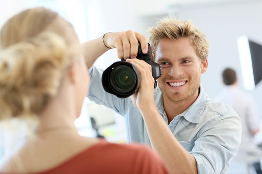 Fashion photographer shooting model in studio