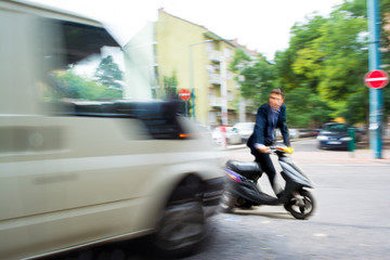 Dangerous city traffic situation with a motorcyclist and a bus