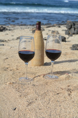 Celebration With Two Glasses Of Red Wine On The Beach