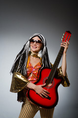 Obraz premium Guitar player with red instrument