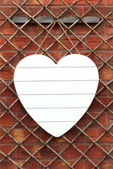 Shabby Chic white heart against brick wall
