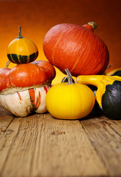 Decorative pumpkins on old wooden table