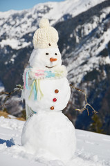 Snowman against Alpine panorama