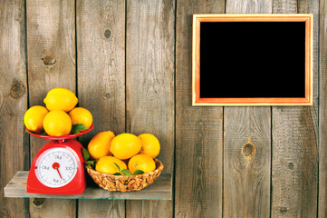 Obraz na płótnie Canvas Lemons on scales and in a basket