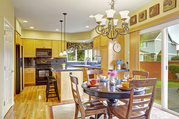 Kitchen with dining area and exit to backyard
