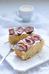 Plum cake with coffee, selective focus