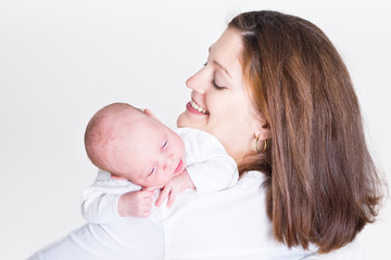 Young beautiful mother holding her newborn baby