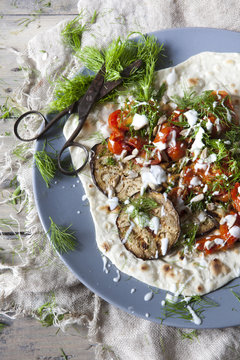flatbread with grilled eggplants tomatoes fennel herb and yogurt