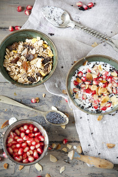 pomegranate grains and bowl of yogurt with seed and muesli
