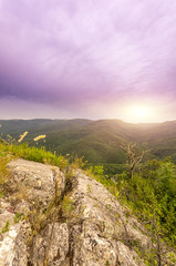 view of sun lazily rising from behind the mountains
