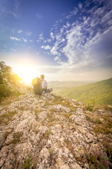 people tired after climbing the mountain admiring the sunset