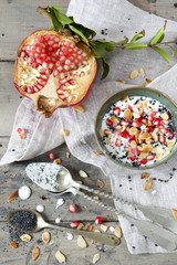 pomegranate and white yogurt with grains and almonds